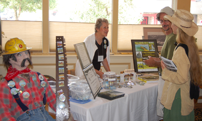 Author Ada Jarvis (left) talks with two visitors in the 2009 Homecoming registration room at the Regent Inn last Friday about her campaign to raise money to purchase a headstone for Edward Mulvehill, the first operator of the 12 Mile Ferry beginning in 1923. He died in 1938 and although Mulvehill Creek and Falls were named in his honour, he was buried without a grave marker at Mountain View Cemetery in Revelstoke David F. Rooney photo