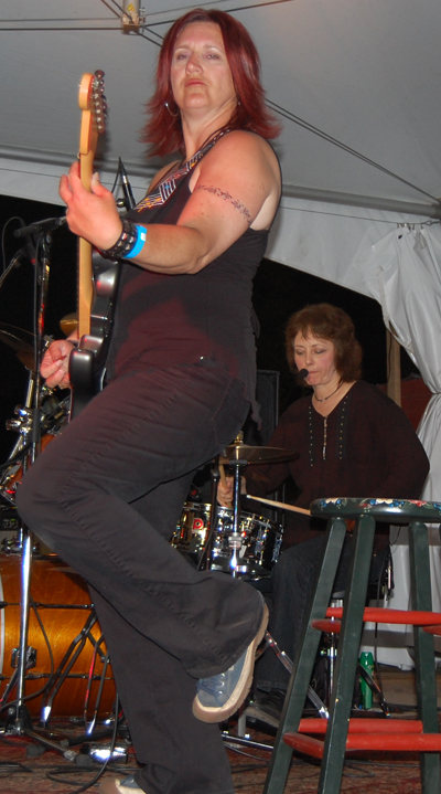 Rhythm guitarist Wanetta Stroo gets right into her performance on Friday. David F. Rooney photo