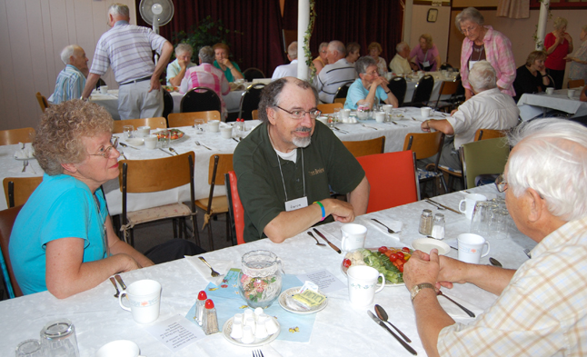 Liz and Harvie Barker talk with Paul Salva at the United Church's Homecoming dinner Saturday. Barker, for years the local United Church minister and weekly newspaper columnist, is now retired and living in Penticton. David F. Rooney photo