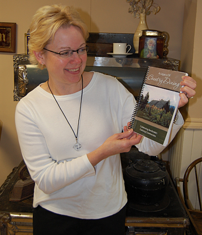 Merilee Planden shows off the cookbook, A Legacy of Country Dining, that the Revelstoke Museum & Archives commissioned to coincide with the 2009 Homecoming celebration later this month. The book features recipes from residents who lived outside of the city limits as far south as Arrowhead. David F. Rooney photo