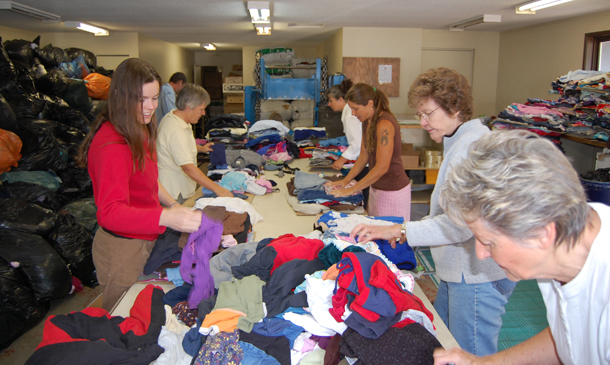 Volunteers fold and prepare used clothes being shipped to African countries of Lesotho and Swaziland and the Pacific island country of Fiji. David F. Rooney photo