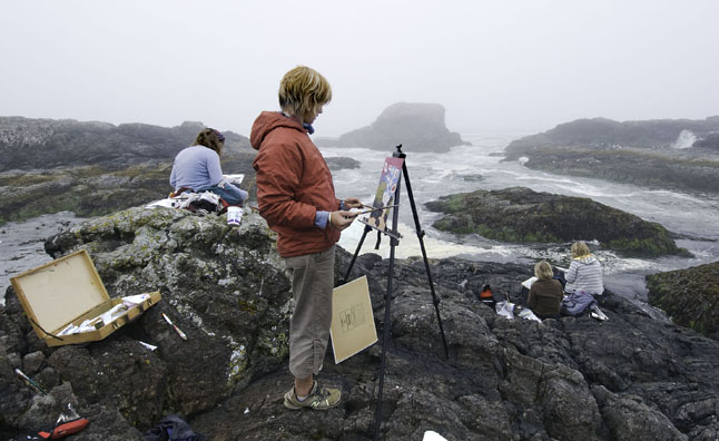 Artists (from left to right) Gwen Lips, Nicola McGarry, Tina Lindegaard and Cherie Vanoverbeke paint on the rocks at South Beach. Photo courtesy of Cherie Vanoverbeke