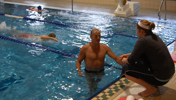 Masters' Swim Club member Alex Szirmai talks with coach Megan Pilla at the Aquatic Centre. The club helps both competitive and non-competitive swimmers achieve their goals. David F. Rooney photo