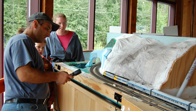 Model railroader Rob Palumbo shows some visitors to the Railway Museum how the trains work. David F. Rooney photo