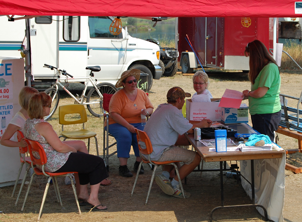 Staff at the Alcan Nancy Green tent discuss their next course of action for the grads servicing the campgrounds at centennial park. . David F. Rooney photo