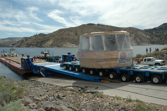 A mammoth 188-tonne turbine bound for the Revelstoke Unit 5 project is disembarked from a barge prior to being portaged around the Grand Coulee Dam on the American portion of the Columbia River. The Brazilian-made turbine is so large that it must be barged up the Columbia, with portages around all dams, to Shelter Bay from whence it will be trucked to the project site. It should be arriving in Revelstoke sometime between August 17 and August 20. Photo courtesy of BC Hydro