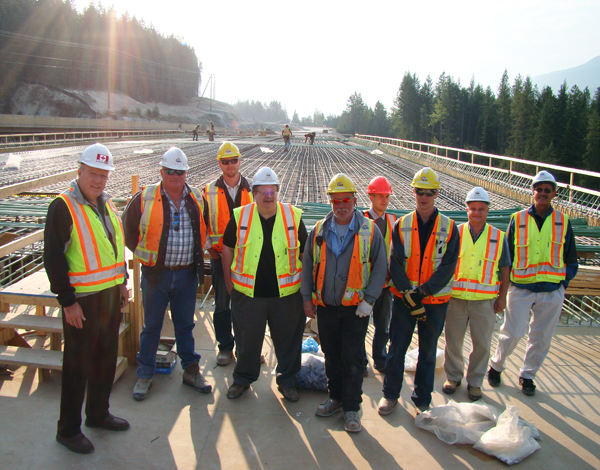MP Jim Abbott (left) poses with workers on the Trans-Canada Highway during his swing through the riding late last month. Photo courtesy of MP Jim Abbott
