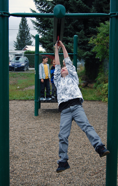 Ahhh! Recess! A boys hurls himself along the zipline at the Mount Begbie playground. David F. Rooney photo