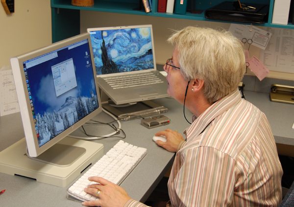 District 19 Superintendent Anne Cooper logs onto her computer after spending the morning touring the schools and ensuring everythign was proceeding smoothly. David F. Rooney photo