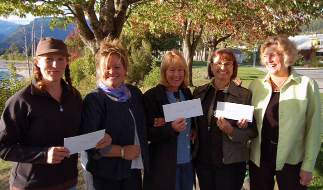 Two of the women of Beta Sigma Phi, Donna Lecompte (second from the left) and Bonnie Teed (second from the right) pose with representatives from three local organization they have assisted this fall through timely cash infusions: Anne Corrie, co-ordinator of the Community Connections Youth program (left), Brenda Kessler, executive director of the Revelstoke Hospice Society and Nelli Richardson, executive director of the Women;s Shelter representing Community Response Network Co-ordinator Mengia Nicholson. The international sorority donated $500 to the Youth Program and $250 each to Hospice and CRN. Corrie said she'll use the money to defray the costs of feeding the kids who attend the afternoon youth program activities. Kessler said the money will go towards the purchase of a new medical mattress for patients in the Hospice Room at Queen Victoria Hospital while Richardson said Nicholson plans to use her money to keep local CRN programs going in the wake of provincial funding cuts. Lecompte and Teed said the sorority was very pleased it could assist three organizations. It is also planning a major fund-raiser this month: the THRILLusion Magic Show at RSS on Oct. 15 at 7 pm (please click on the Big Box ad in the Community Section to find out more about this great local event). David F. Rooney photo