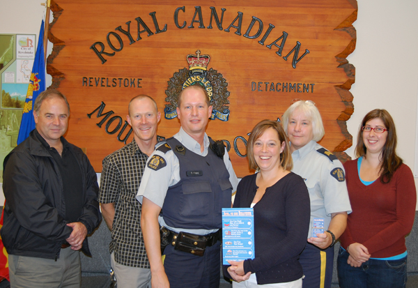 Local Mounties may be stopping mor elocal youths in the coming days and weeks but the odds are good it won't be to give them heck. No, these days they'll be more likely to Bust Them for Good Behaviour. Well, that's the name of the program put together by Caroline Grenier (center right) of the Ministry of Children and Family Development (MCFD). The MCFD program wants to improve the relationship between young people and the RCMP. It is supported by local businesses A&W and Chevron, as well as the City of Revelstoke and the Arts Council. In this photo are, from left to right, Mayor Dave Raven, MCFD Team Leader John Yakielashek, RCMP Cpl. Rod Wiebe, Carole Grenier, Staff Sgt. Jackie Olsen and the Arts Council's Melanie Nadeau. David F. Rooney photo