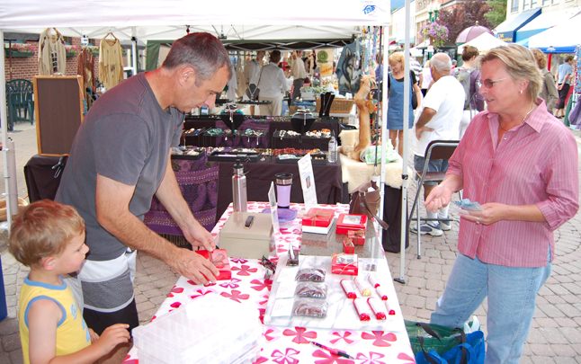Rich Mulligan wraps up a tasty selection of hand-made chocolates from the Chocolate Summit for Loni Parker at the Farmers' Market on Saturday. There are only eight more Saturday Farmers' Markets for you to enjoy so make the most of them while they're on this year. David F. Rooney photo