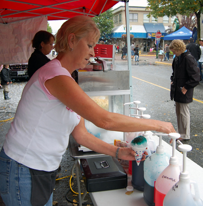 Chris Deverall of Team Gloria whips up a blueberry sno-cone for a thirsty/hungry customer. David F. Rooney photo