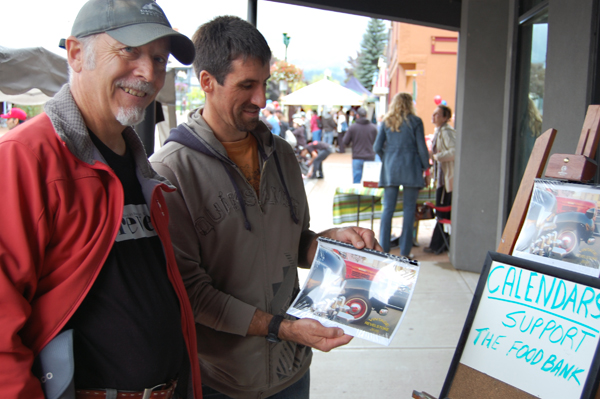 Brent Lea did a good business raising money for the Food Bank by selling calendars featuring hot and very old cars. It was a deal Jeff Weston (centre) couldn't pass up. David F. Rooney photo