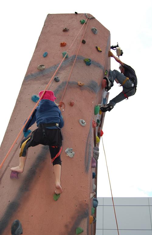 Adventurous youths scale the climbing wall, which was one of the most popular events for young people Saturday. David F. Rooney photo