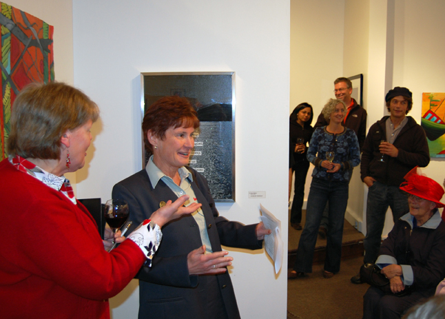 Visual Arts Centre Director Jackie Pendergast (left) and Mount Revelstoke and Glacier National Parks Superintendent Karen Tierney share a light moment before their speeches to the crowd that attended the opening of From the Mountains to the Sea on Friday. David F. Rooney photo  