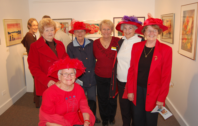 Pat Anderson poses with some of her friends, the Red Hat Ladies. The popular watercolourist enjoyed her own opening on Friday night: Seeing Red. Like From the Mountains two the Sea, her show runs until Nov. 6. David F. Rooney photo