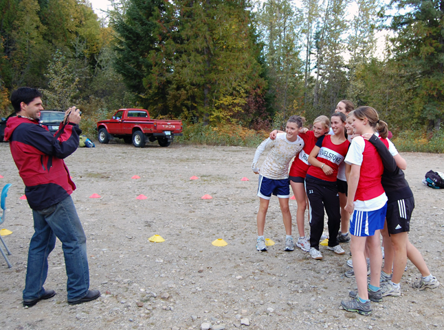 RSS teacher Rory Luxmoore takes a group photo of the RSS girls who limbered up for a cross-country run against several other regional schools at the Mount Macpherson ski area Wednesday. David F. Rooney photo