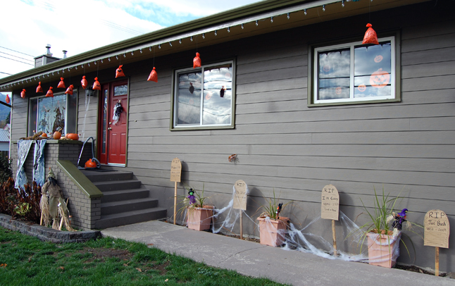 The Meloros at 705 Vernon transformed their front garden into a graveyard with their home-made tombstones. David F. Rooney photo