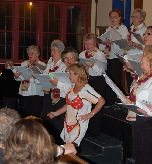 ... provoked real laughter as Jan Highes sashayed out from behind wearing a bikini T-shirt for the choir's performance of Little Yellow Polka Dot Bikini. David F. Rooney photo