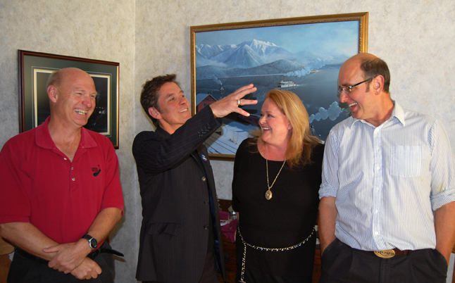 Revelstoke Teachers' Association President Bill MacFarlane (center) gestures as he poses with School District Chairman Alan Chell (left), District PAC Chairwoman Kathryn Tompkins and former RTA president Gord Robinson at the RTA's tea party to mark World Teachers' Day on Monday afternoon. David F. Rooney photo