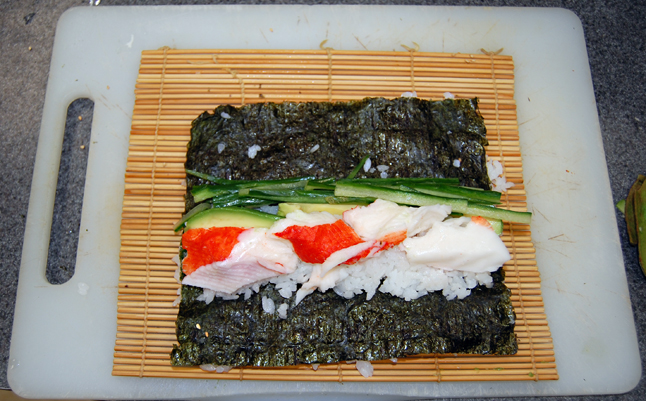 Ready for rolling, this rice, cucumber and crab filling sits on a sheet of green seaweed. David F. Rooney photo