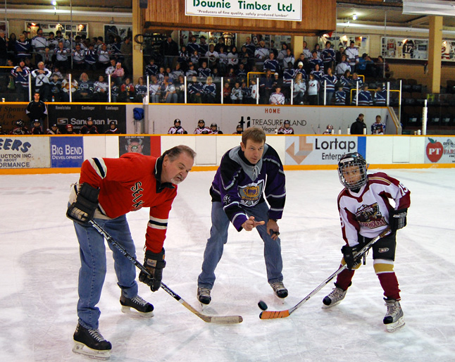 John Macko, a defenceman for the Revelstoke Selkirks back in the 1970s, faces off against Matt Cadden, a member of the Revelstoke Minor Hockey Association's Novice team as John Leeder drops the puck for a ceremonial face-off symbolizing the passing of hockey tradition from one generation to another. The event was held at the Forum on Sunday afternoon as part of the campaign to win Hockeyville status for Revelstoke. David F. Rooney photo