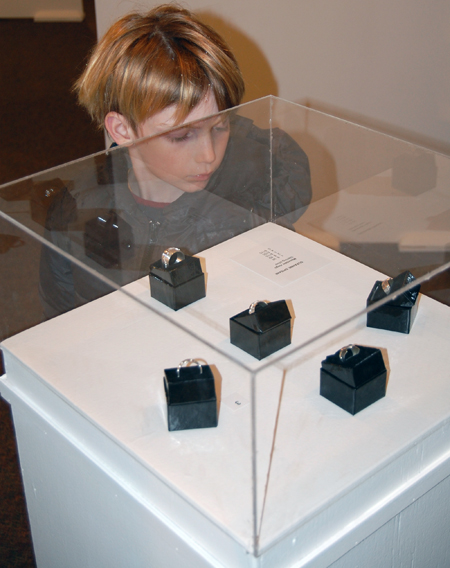 This youngster was mesmerized by Suzanne Spisani's display of silver rings.  David F. Rooney photo