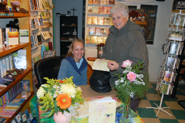 Mieke Blommestein signed a copy of her first book, The Tale of Miss Spider Who Spun Her Web, for Marie Pratico at Grizzly Books on Friday evening. Three local residents — Blommestein, John Baker and Chic Sharp — have published their first books this year. A fourth, Frieda Livesey, will also be publishing one in the weeks to come. David F. Rooney photo