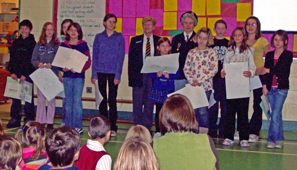 Sue Driediger (center left back), president of Royal Canadian Legion Branch 46 and Helen Grace (center right back) poses with the Columbia Park Elementary School students who were winners in the annual Poppy Poster Contest. The winners from CPE were: Anna Pfeiffer,Grayson Norsworthy, Melinda Brown, Jessie Booker, Lily Michaels, Takara Tompkins, Alexis Pilon, Dani Alm, Kane Campbell and Stephanie Batke, Photo by student photographer Kelsey Marsh