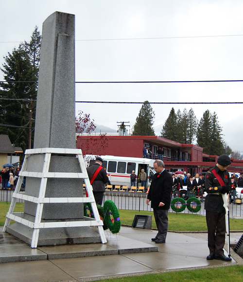 Mayor David Raven stands in silence before the Cenotaph after laying a wreath on behalf of the City of Revelstoke. David F. Rooney photo