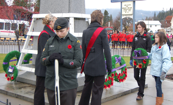 Arrow Heights Elementary students Jacqueline Cottingham and ?? approach the Cenotaph to lay a wreath on behalf of their school. David F. Rooney photo