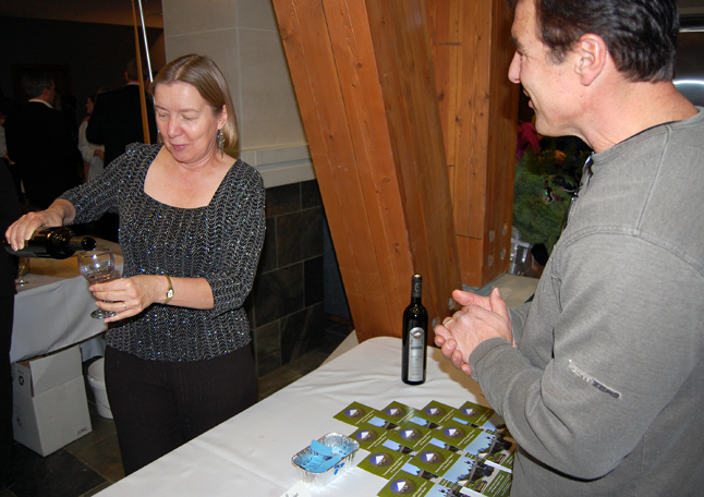 Tuulikki Tennant serves up some vino for friend and neighbour Lawrence Nagy.  David F. Rooney photo