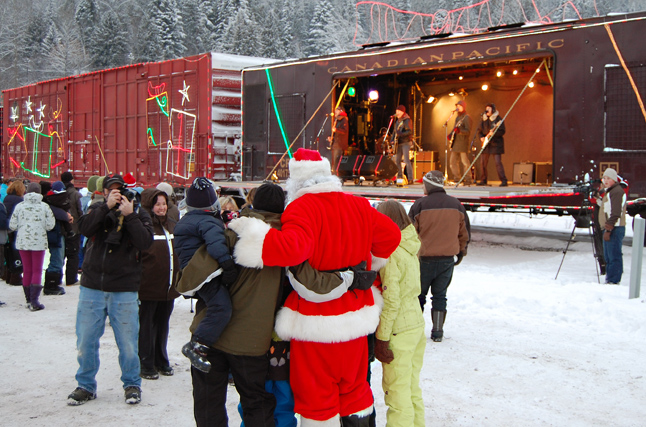 Santa Claus poses for a photo with some new-found friends at the Holiday Train party. David F. Rooney photo