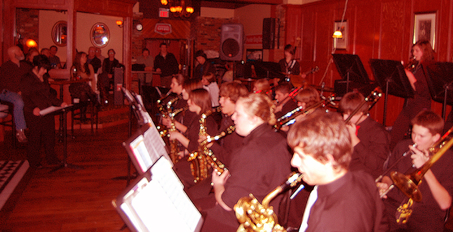 The RSS Senior Jazz Band packed 'em in at the Last Drop when they played for an hour on Wednesday evening. The young musicians, led by instructor and conductor Tessa Davis, played exceptionally well to a standing-room-only crowd. The same cannot be said for the photographer who inadvertently hit a switch on the lens of his Nikon changing from autofocus to manual focus. Of the 19 photos I took, this was the only one that was even marginally usable. Ah, where would we be without human error? It certainly doesn't do the kids justice, but, boy, were they good. David F. Rooney photo 