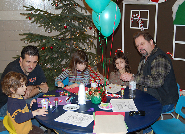 Wally Veninsky (left) and Bob Loeppky (right) have fun with their kids, Samantha, Zach and Mercedes at the kids' fun table. David F. Rooney photo