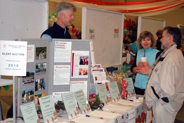 Kevin Lavelle and Linda Dickson of the Revelstoke Community Foundation talk with Rene Hueppi about the good works the Foundation performs and, ideally, about some of the silent auction items it had on offer Sunday.  David F. Rooney photo
