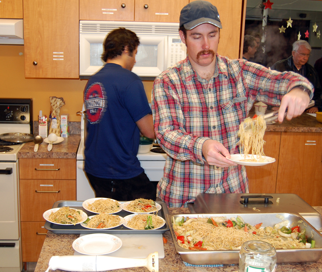 Stephen Brown dishes out the Chow Mein as Gerard Goshgarian stirs the soup. David F. Rooney photo
