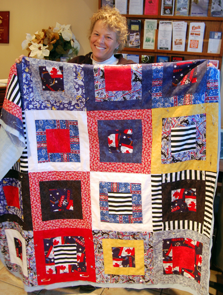 Suzie Cameron shows off the quilt she has made as a fund-raiser for the Revelstoke Hockeyville Committee. The Committee is planning a draw for this lovely work. Details will be announced as they become available. David F. Rooney photo