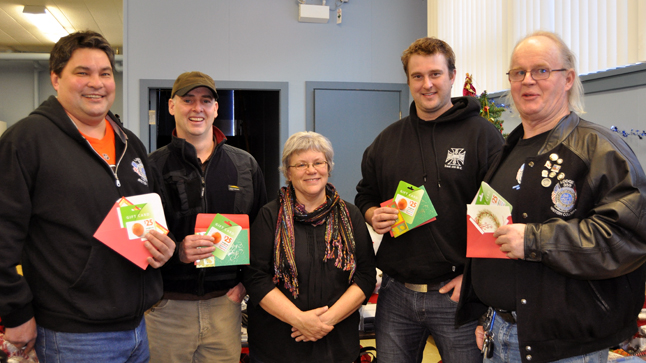 These four burly guys — (left to right) J'onn Giese of Kamloops, Rick McIsaac of Revelstoke, Adam Saunders of Diuncan and Jim Wymer of Kamloops — drove down from Mica with 100 gift cards worth $25 each to give Patti Larson for the Christmas Hamper program. J'onn said they like to do this every year.  David F. Rooney photo