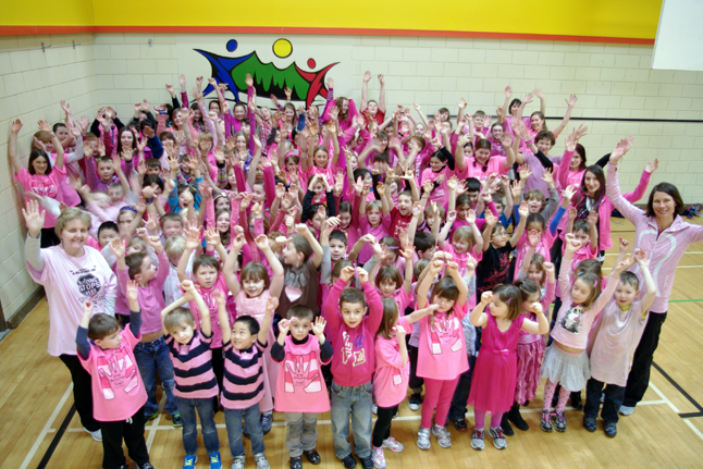 Raise your hands against bullying!  Students and staff at Arrow Heights Elementary School wore pink to show their support against bullying on February 27.  Big Buddies and Little Buddies got together after this picture was taken to participate in making friendship bracelets. Photo by Student Photographer Julian Corbett