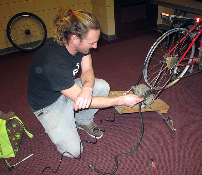 For Sean Bozkewycz, biking isn’t just about getting around.  The passionate environmentalist is generating electricity while he cycles around town.  His bike runs an alternator that is plugged into a deep cycle battery and a few hours of cycling generates enough power to run a stereo – even a film. Laura Stovel photo