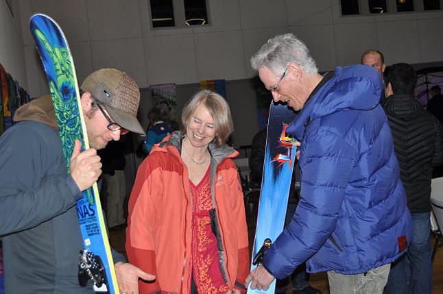 Darcy Purcell (left), Deane Brebner (center), and Don Bissonnette (right) admire skis up for auction at the Home for the Hunts fundraiser. Laura Stovel photo