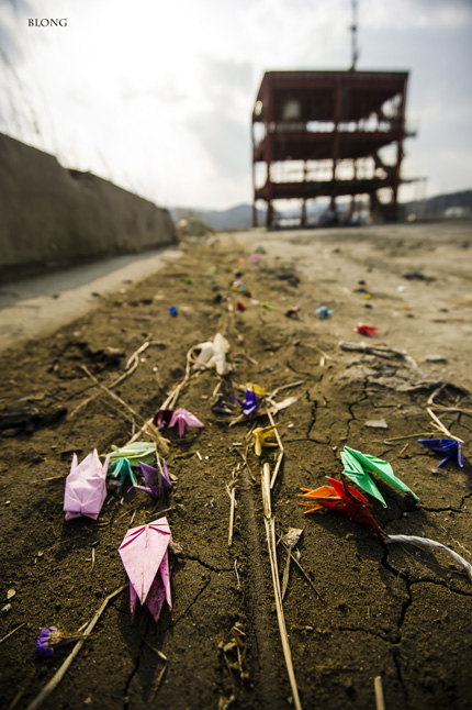 Tiny paper cranes litter one of the sites of the March 2011 disaster. Bruno Long photo