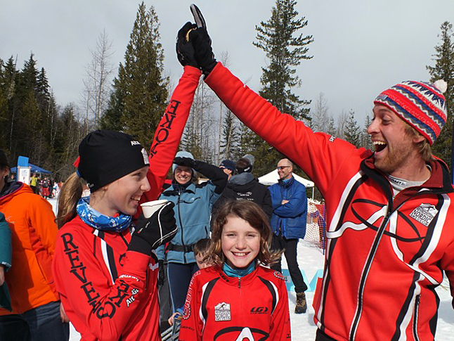 Revelstoke Coach Matt Smider congratulating Elizabeth Elliott for her bronze medal in Sunday’s sprint championship. Little Sister Jaclyn has lots to smile about too, on Saturday she earned a 4th place ribbon in the 2.5 km interval classic race. Sarah Newton photo