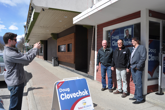 Kyle Marsh (left) snaps a quick pic of BC Liberal candidate Doug Clovechok (right) posing the Randy Biggs and Mark McKee in front of the party's Revelstoke campaign office at 308 First St W,  across from Your Office and Art Supply store. Clovechok will be in Revelstoke for the week and will be campaigning door to door and attending a number of private meetings with supporters. He will also be participating in the Chamber of Commerce's official debate, which is scheduled for April 22 at the Community Centre at 6:30 pm. The debate will be moderated by former mayor Geoff Battersby. David F. Rooney photo