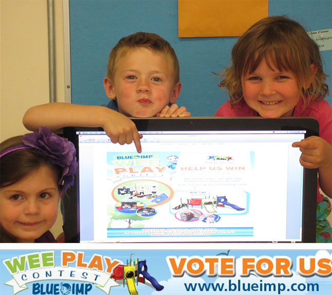 Suri Stewardson, Connor Holahan and Emma Mair show where you can vote for a new playground structure for AHE. Photo by Student Photographer Julian Corbett