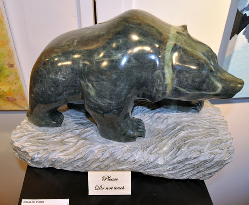 Despite the sign, this stone bear by Chuck Purse begs to be touched, 