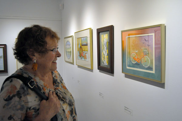 Tannis Rebbetoy really liked Sherrin Davis' lovely painting, Think of Bicycles as Rideable Art, which was one of works in the Golden Girls' exhibition that opened on Friday at the Revelstoke Art Gallery. David F. Rooney photo