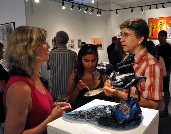 Poppi Reiner chats with David Walker and his daughter Taryn during the opening on Friday. David F. Rooney photo